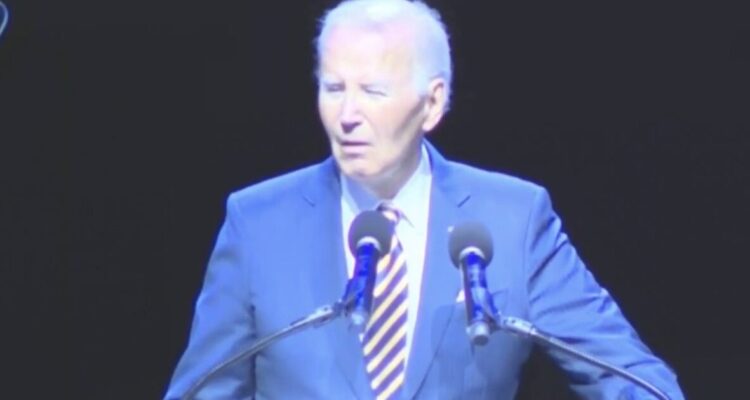 Joe Biden speaking at the Maryland Democratic Party gala while protesters heckle him