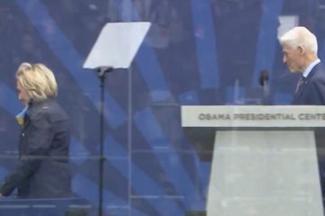Hillary Clinton bundled up in a coat and scarf at the Obama Presidential Center opening ceremony in Chicago