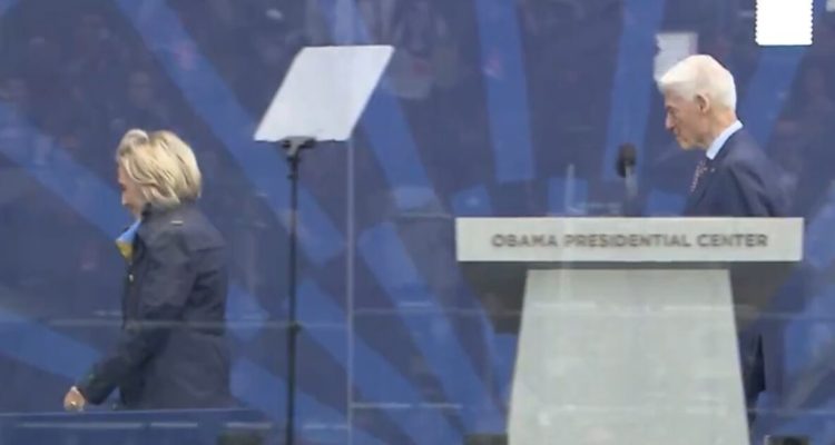 Hillary Clinton bundled up in a coat and scarf at the Obama Presidential Center opening ceremony in Chicago