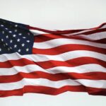 American flags near a Massachusetts beach community with dunes in the background