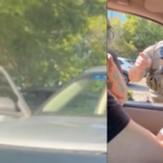 Video still of a woman in a vehicle during a confrontation with ICE agents
