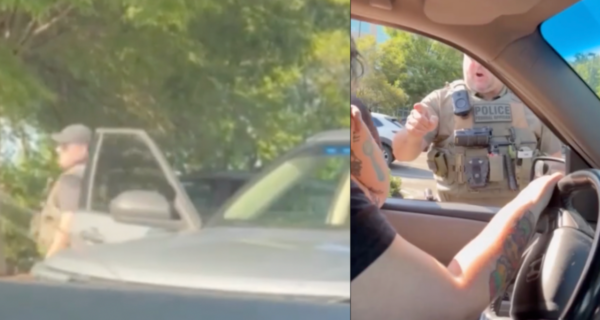 Video still of a woman in a vehicle during a confrontation with ICE agents