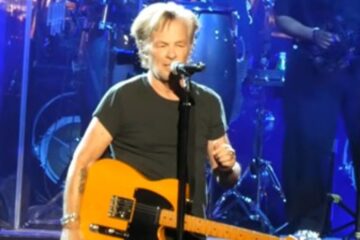 John Mellencamp performing on stage during a concert