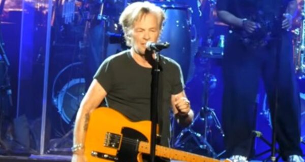John Mellencamp performing on stage during a concert