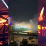 Smoke and flames seen on the Brooklyn Bridge during a Fourth of July fireworks show in New York City