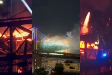 Smoke and flames seen on the Brooklyn Bridge during a Fourth of July fireworks show in New York City