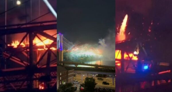 Smoke and flames seen on the Brooklyn Bridge during a Fourth of July fireworks show in New York City