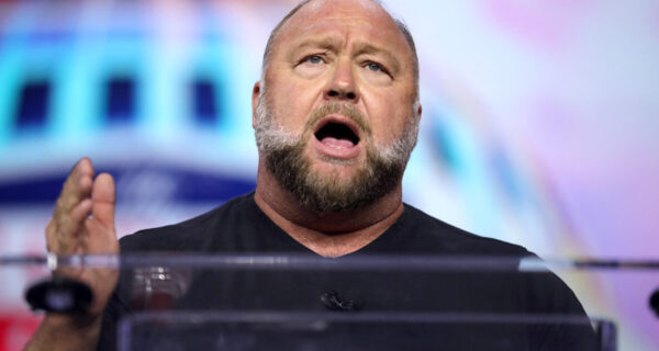 Alex Jones celebrates a Texas appeals court ruling reducing the punitive damages in a Sandy Hook case