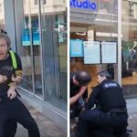 British police officers detain a man carrying a baseball bat still in its store packaging as bystanders protest