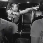 Two Houston police officers enter an Uber driver’s car while pursuing a fleeing suspect