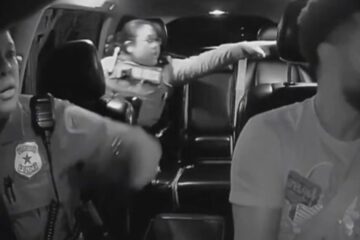 Two Houston police officers enter an Uber driver’s car while pursuing a fleeing suspect