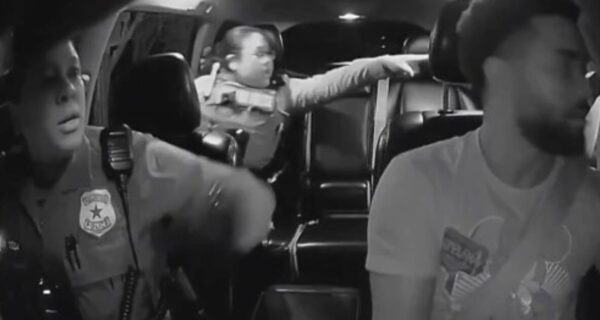 Two Houston police officers enter an Uber driver’s car while pursuing a fleeing suspect