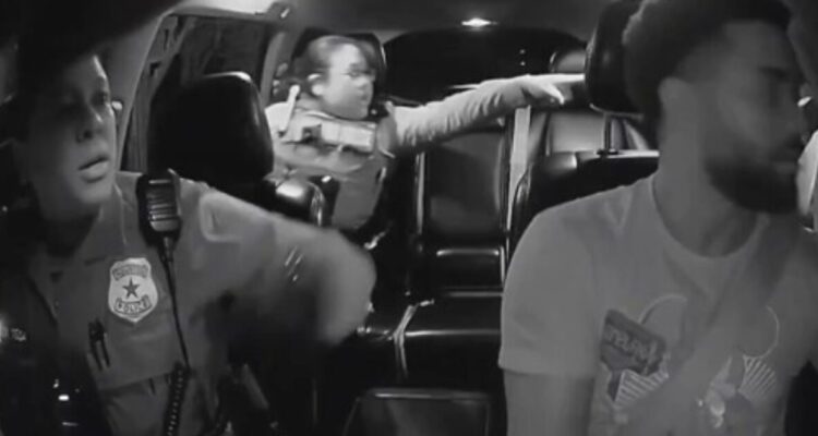Two Houston police officers enter an Uber driver’s car while pursuing a fleeing suspect