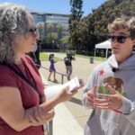 Nick Shirley speaks with New York Times reporter Laurel Rosenhall outside the California State Capitol