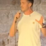 Mike Hammock performing a comedy set while discussing Lindsay Clancy supporters