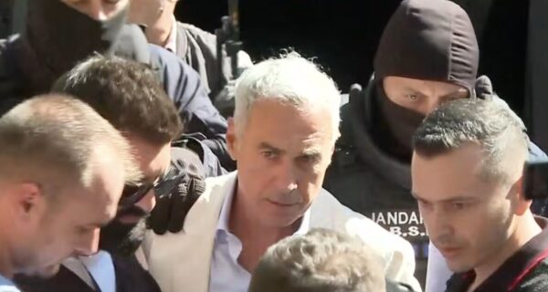Călin Georgescu escorted in handcuffs after a Romanian police raid