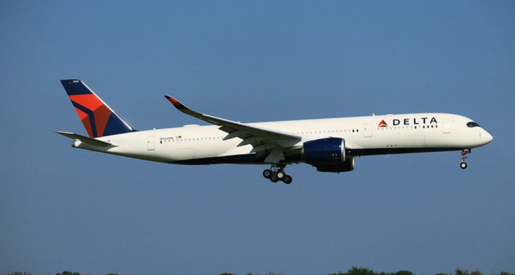 Police escort a disruptive Delta passenger off an aircraft before takeoff at JFK Airport