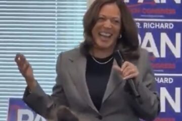 Kamala Harris laughs during a campaign event with Richard Pan as staffers sit quietly