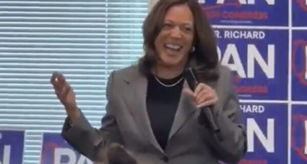 Kamala Harris laughs during a campaign event with Richard Pan as staffers sit quietly