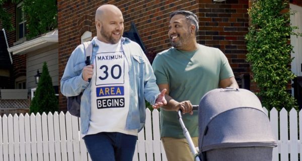 Social media image showing two men pushing a stroller, with one wearing a shirt reading “Maximum 30 Area Begins”
